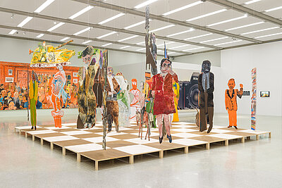 Artistic installation in the form of a chessboard with colourful cardboard figures on it
