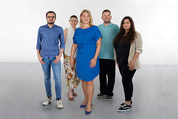 
            
                a group of people standing in front of a white wall: the finance team at mumok
            
        