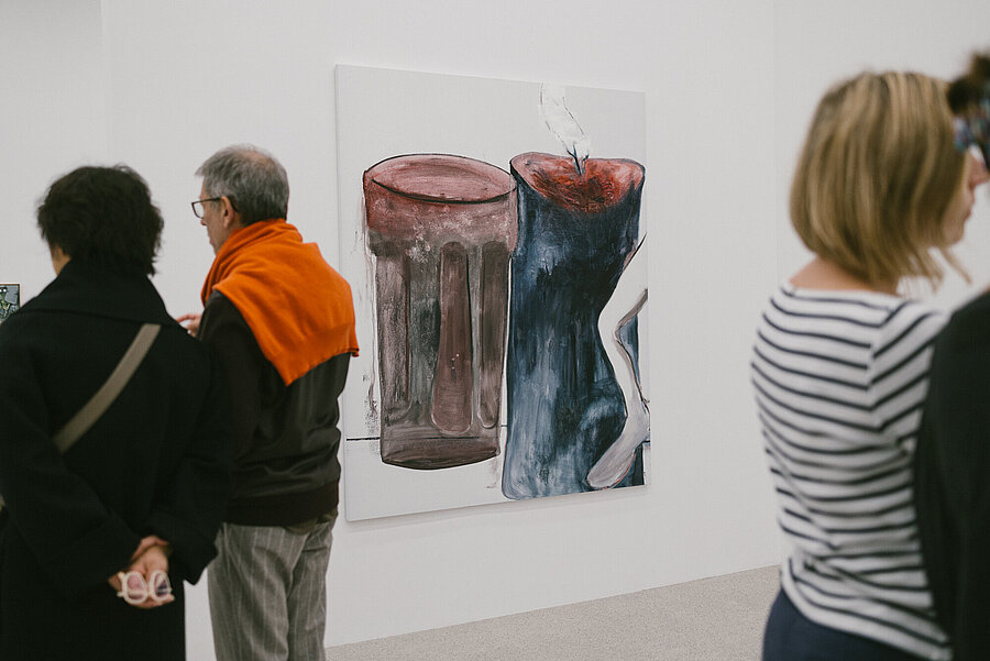 Visitors in the Tobias Pils. Shh exhibition at mumok, standing in front of color-reduced paintings.