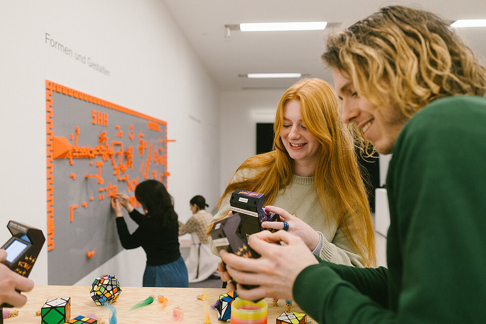 Erwachsene und Kinder in der mumok Freispielstation mit verschiedenen Spielsachen und Materialien