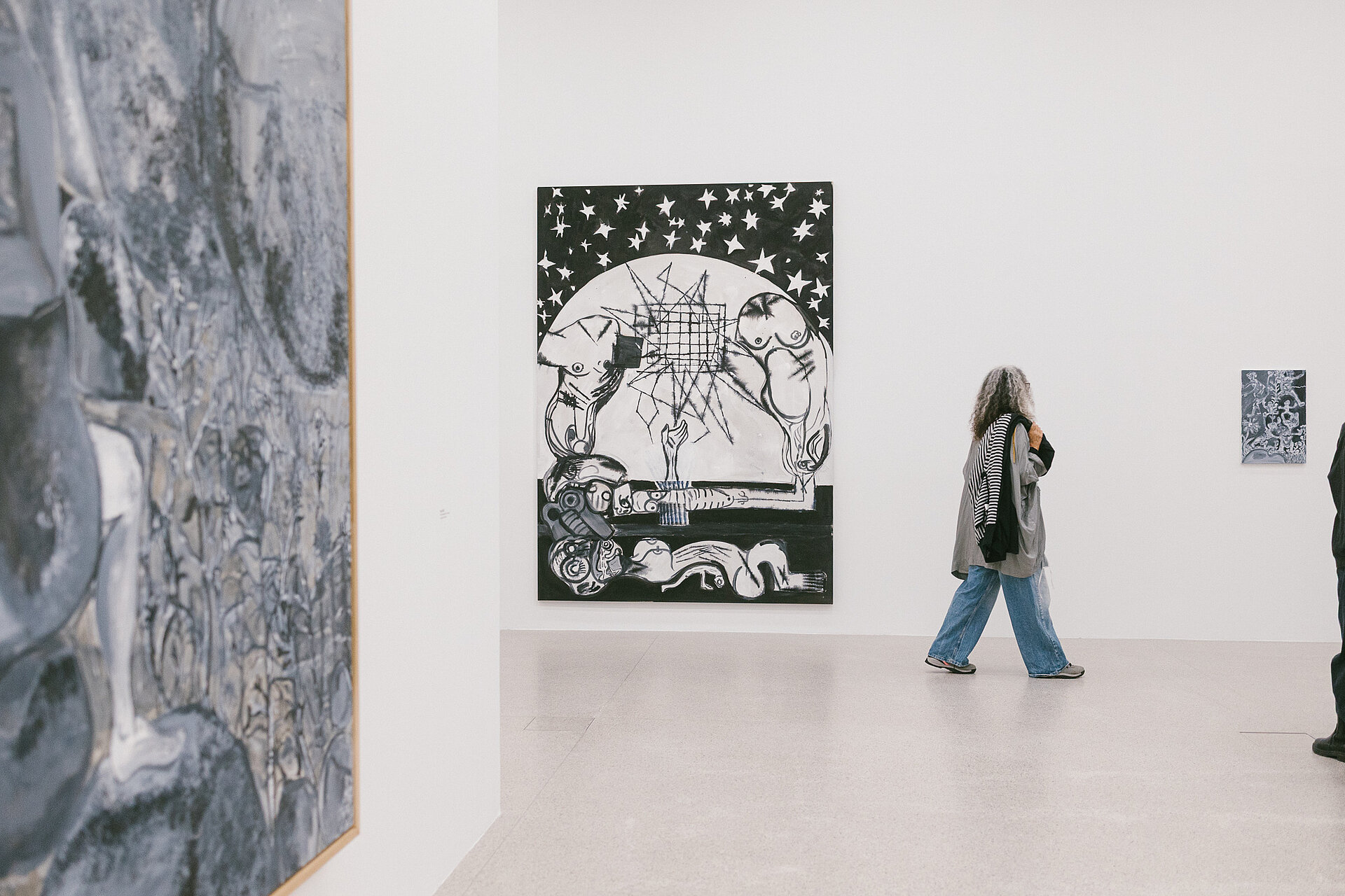 Visitors in the Tobias Pils. Shh exhibition at mumok, standing in front of color-reduced paintings.