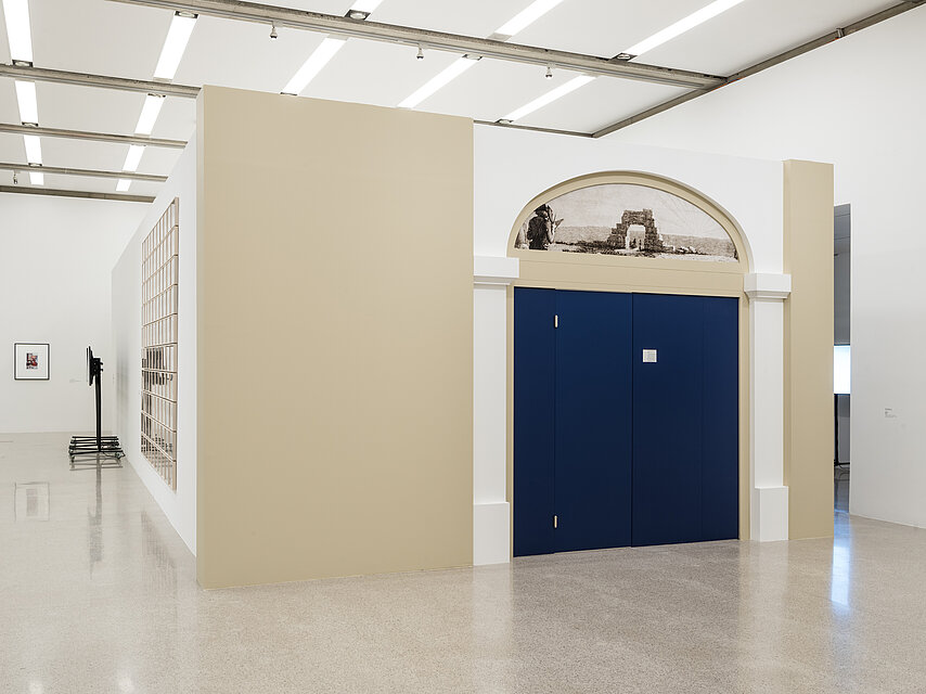 Exhibition room, inside another room with a blue door