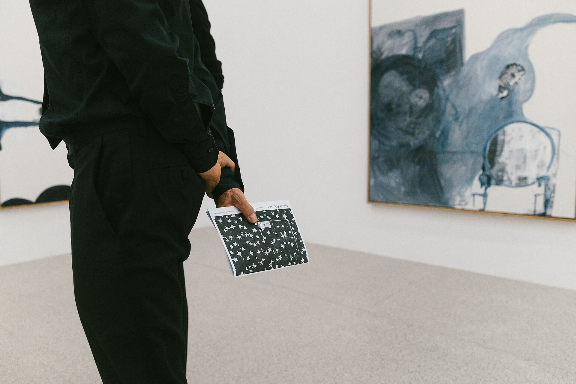 Visitors in the Tobias Pils. Shh exhibition at mumok, standing in front of color-reduced paintings.