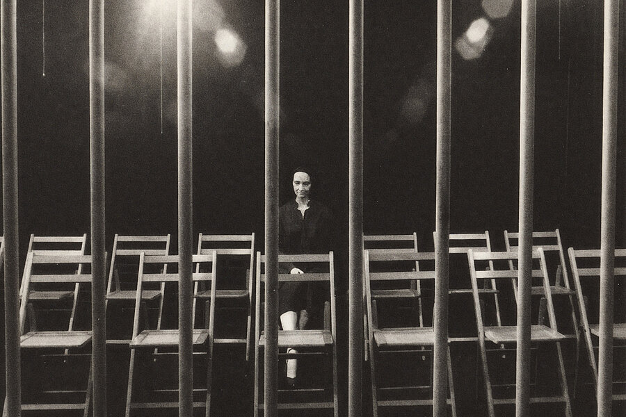 Kate Millett, Terminal Piece: a sculpture of a woman seated on a chair; several additional chairs are positioned beside and in front of her, with metal bars in the foreground.