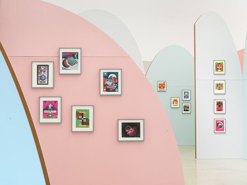 Colourful, semi-circular walls in pastel colours, with colourful collages in A4 format on them