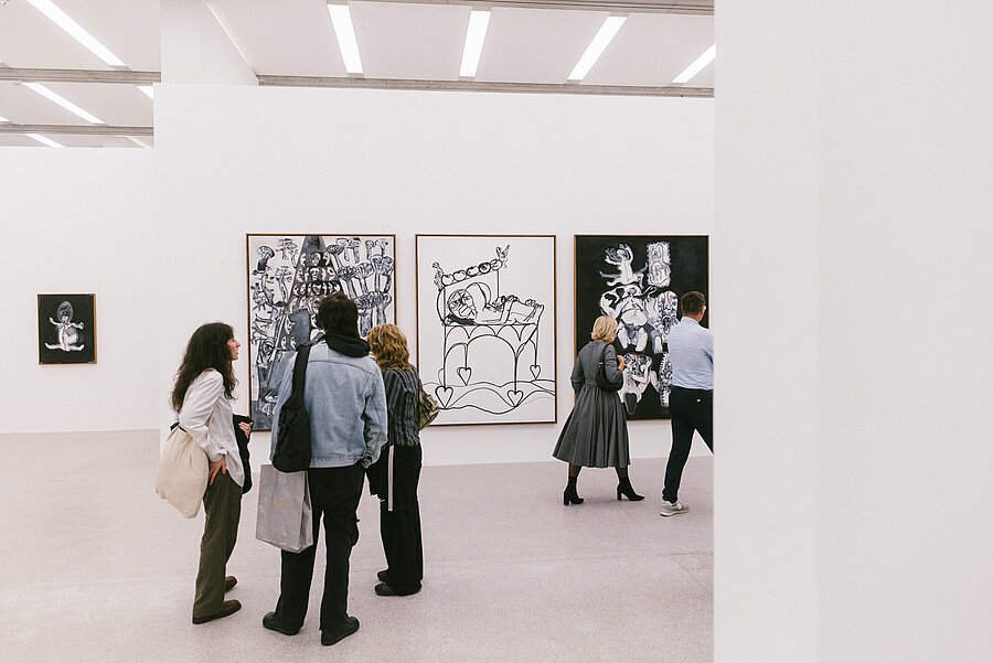 Visitors in the Tobias Pils. Shh exhibition at mumok, standing in front of color-reduced paintings.