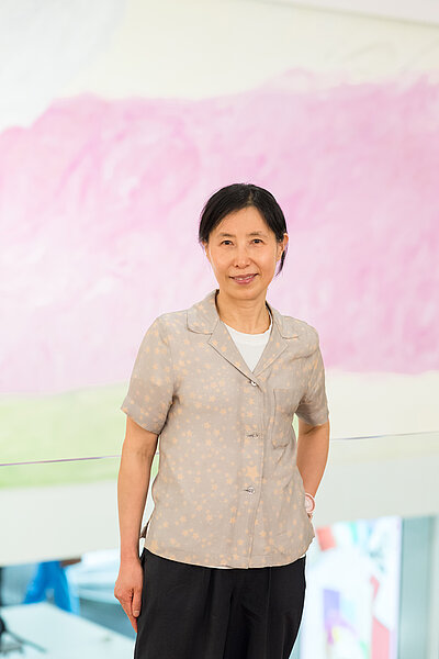 Jongsuk Yoon in front of the mural Kumgangsan, 2024
