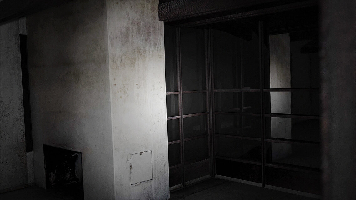 A dark interior space with off-white, slightly stained walls and built-in shelving units. Low lighting creates strong shadows throughout the room.